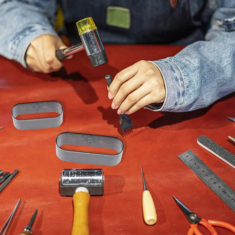 Leather Die Punch Cutter Set In Steel With Hollow Punch Tools For Cutting Leather on crafting table with person using hammer