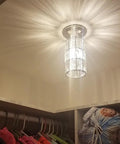 Two Pack 5 Inch Crystal Pendant Lights With Brushed Nickel Finish illuminating a closet, showcasing modern crystal shade design.