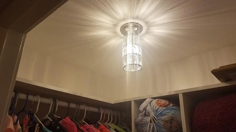Two Pack 5 Inch Crystal Pendant Lights With Brushed Nickel Finish illuminating a closet, showcasing modern crystal shade design.