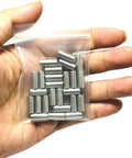 Top Grade 25 Pack Of 6Mm X 12Mm 304 Stainless Steel Dowel Pins in a clear bag held in a hand, ideal for woodworking projects.