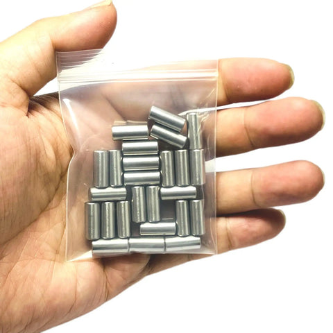 Top Grade 25 Pack Of 6Mm X 12Mm 304 Stainless Steel Dowel Pins in a clear bag held in a hand, ideal for woodworking projects.