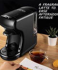 Compact Capsule Coffee Machine With Built In Grinder And Steam Wand For Home Or Office Auto Brew Easy To Use Brews Small Or Large Cups Sleek Modern Design Perfect For Quick Barista Quality Espresso And Lattes on a countertop next to a cup of coffee and a plant.