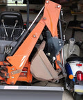 Tractor with Heavy Duty Backhoe Thumb Excavator Claw For 3.25 Inch Boom Width Beefy Steel Attachment in a garage
