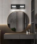 Two Light Bathroom Vanity Light In Matte Black Modern 16W LED Dimmable Over Mirror With 350 Degree Adjustable Head Cold White 6000K ETL Listed 15.5 Inch installed above round mirror in modern bathroom.