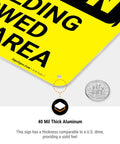Close-up of No Welding Allowed In This Area Sign Durable Aluminum For Indoor Outdoor Use showing thickness next to a dime