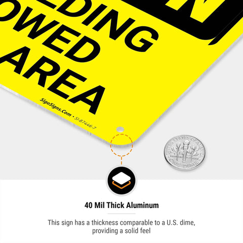 Close-up of No Welding Allowed In This Area Sign Durable Aluminum For Indoor Outdoor Use showing thickness next to a dime
