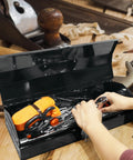 Heavy Duty 16 Inch Hip Roof Portable Steel Toolbox With Dead Tight Metal Latch And Corrosion Resistant Powder Coating Tough Wall Mount Or Bench Organizer For Gearheads And Pros Black open with tools inside on a workbench.