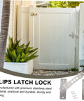 Stainless Steel Sliding Barn Door Lock And Latch Heavy Duty Rotating Hasp With Secure Gate Bolt Built Tough For Cranked Tight Security And A No Fuss Setup To Keep Your Spot Locked Up Smooth installed on a white gate with green plants.