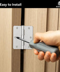 Top Shelf Interior Door Hinges In Brushed Nickel With Rounded Corners Solid Iron Residential Hardware being installed with a screwdriver.