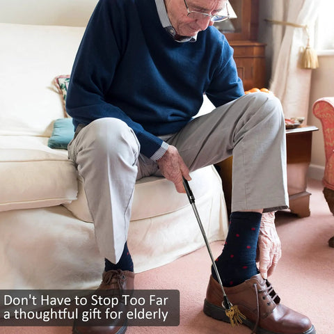 Elderly man using extendable magnetic flashlight tool as gift