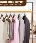 Solid Walnut Wood Coat Hangers Six Pack With Extra Wide Shoulders And Non Slip Pants Bar displayed on rack with clothes