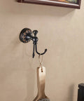 Oil Rubbed Bronze Towel Hooks Set with round floral base and wooden brush, wall mounted in a bathroom setting.