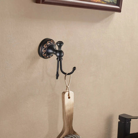 Oil Rubbed Bronze Towel Hooks Set with round floral base and wooden brush, wall mounted in a bathroom setting.