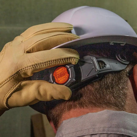 Worker adjusting strap on Rugged Worksite Ready Hard Hat With Rechargeable Headlamp Full Brim Non Vented Safety Helmet