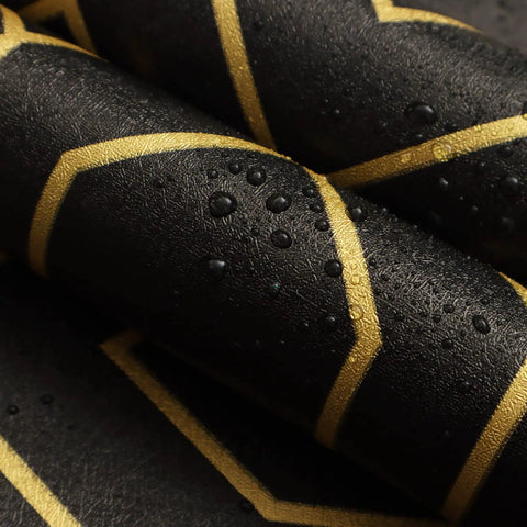 Geometric Gold And Black Peel And Stick Wallpaper close-up showing modern diamond pattern with water droplets on vinyl material
