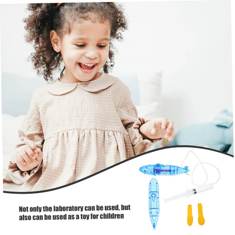 Child smiling with Submarine RC Drone Buoyancy Demo Toy For Kids And Teens. Includes blue model and syringe in image.