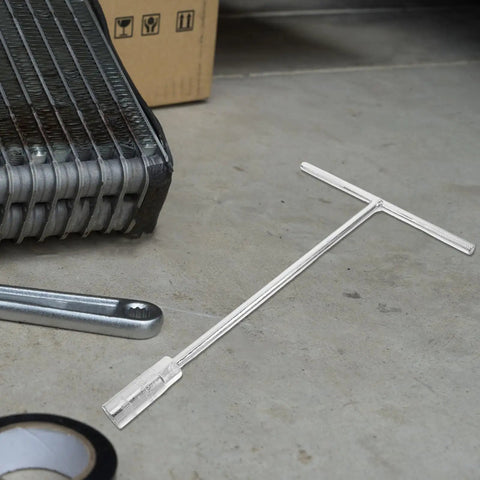 Ergonomic Steering Wheel T Handle Socket Wrench Made From Tough American Steel For Motorcycle Repair on a workshop floor.