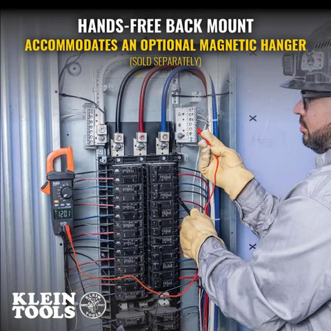 Electrician using Auto Ranging Digital Clamp Meter With True RMS For AC And DC Current And Voltage Resistance tool on panel