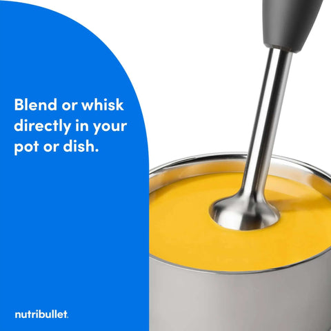 Lightweight Ergonomic Handheld Immersion Blender With Rustproof Stainless Steel Whisk Attachment And Heavy Duty Heat Resistant Shaft For Mixing Straight Out Of The Pot Dark Gray Kitchen Game Changer blending yellow soup in a pot.