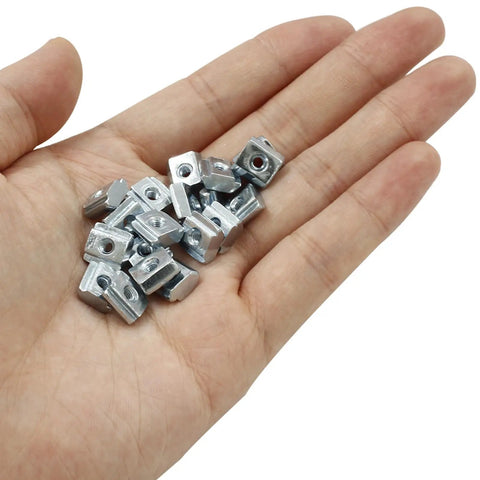 Top Shelf Heavy Duty M3 T Slot Nuts 50 Pack 2020 Profile Sliding T Nuts For Aluminum Extrusion Rails in hand, carbon steel, nickel plated.