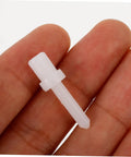 Close-up of a white plastic shutter replacement pin held between fingers, part of Shutter Replacement Pins And Plunger Bolts For Window Screens Feature Heavy Duty Design With Forty Pieces Of Spring Hardware To Give Broken Blinds A No Sweat Fix That Works Like A Dream Indoors Year Round At Home.