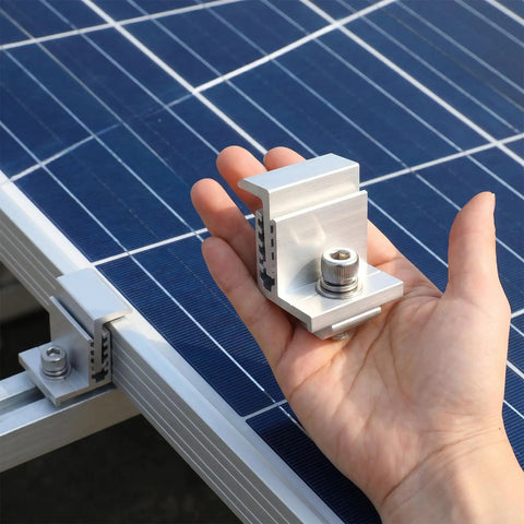 Person holding Eight Piece 35 To 50mm Adjustable Solar Panel End Clamp, showing aluminum material, beside mounted solar panels.