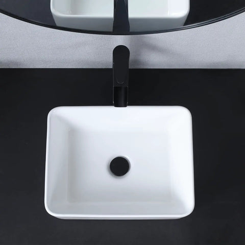 Top view of the Vessel Sink 22 x 15 Inch White Ceramic Above-Counter Bathroom Sink on a black vanity.