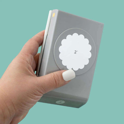Hand holding 2 Inch Scallop Circle Paper Punch for Scrapbooks and Card Making, metal craft punch with stackable design, gray finish