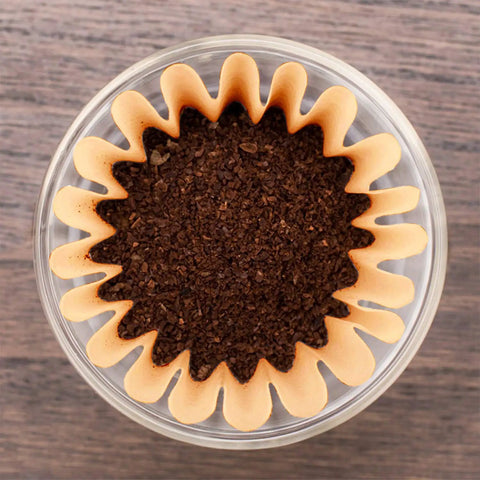 Top view of coffee grounds in a Disposable Coffee Filters For 1 To 4 Cup Basket Makers, Natural Brown Unbleached, 100 Count Pack