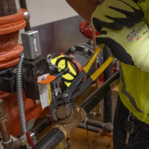 Worker using 12 Inch Quick Adjust Pump Pliers With Tongue And Groove Klaw Push Button Ratchet For Fast Adjustments Narrow Profile