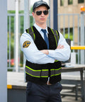 Top Shelf Seven Pocket Mesh Safety Vest In Matte Black For Active Crews Featuring Fly Airflow Polyester worn by a security guard.