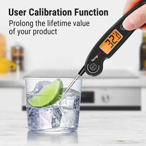 Instant Read Meat Thermometer With 1-Second Accuracy measuring ice water with backlit LCD displaying 32°F in kitchen setting.