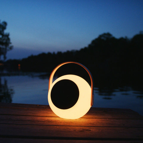 Eye Color Changing LED Lantern With 10W Bluetooth Speaker, White Mood Lamp for outdoors by riverside at dusk.