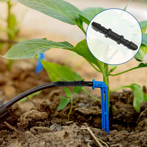 1/4 Inch Quick Connect Drip Irrigation Couplers Kit Dope 100 Black Barbed Connectors installed in garden soil near plants