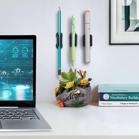 Adhesive Wall Pen Holder 6 Pack Silicone Pencil Marker Stylus Organizer Dual Hole Design on a wall beside a desk