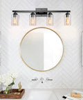4 Light Black Vanity Wall Sconce With Clear Glass Shades, Vintage Industrial Style over round mirror in modern bathroom.