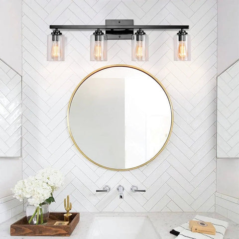 4 Light Black Vanity Wall Sconce With Clear Glass Shades, Vintage Industrial Style over round mirror in modern bathroom.