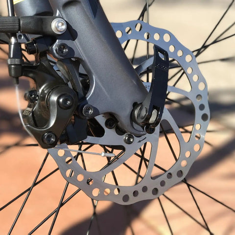 Close-up of Beefy 160mm Disc Brake Rotor for Electric Bikes and Mountain Rides Stainless Steel installed on a bike