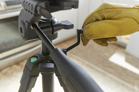 Worker adjusting BT 150 Compact Tripod With Extendable Height For Line Lasers Point Lasers And Laser Distance Measures