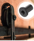 Close-up of Five Pack Sliding Barn Door Spacers Track Wall Mount Replacement Kit Black Connectors in use on barn door track
