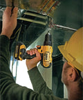 Person using 20V Max Cordless Drill Driver Kit With 100-Piece Bit Set For Home Projects in tight space on metal ductwork.