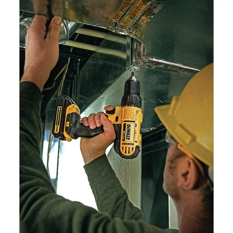 Person using 20V Max Cordless Drill Driver Kit With 100-Piece Bit Set For Home Projects in tight space on metal ductwork.
