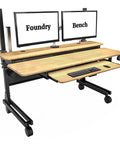 Smooth Bamboo Electric Standing Desk Riser 60 X 30 Inches With Motorized Lift And Easy Rolling Casters showing dual monitors and keyboard.