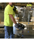 Man using Grabo Nemo Electric Vacuum Suction Cup Lifter to move glass panel, showcasing heavy-duty lifting in action.