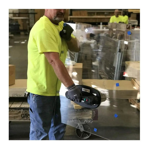 Man using Grabo Nemo Electric Vacuum Suction Cup Lifter to move glass panel, showcasing heavy-duty lifting in action.