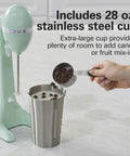 DrinkMaster Electric Drink Mixer For Smoothies And Shakes Retro Milkshake Maker And Milk Frother Two Speeds Extra Large 28 Oz Stainless Steel Cup Mint Finish beside a cup with chocolate chips