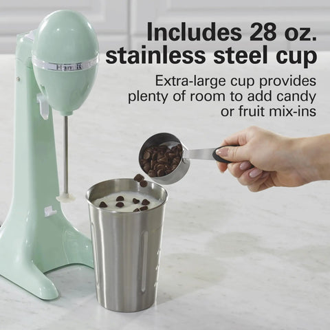 DrinkMaster Electric Drink Mixer For Smoothies And Shakes Retro Milkshake Maker And Milk Frother Two Speeds Extra Large 28 Oz Stainless Steel Cup Mint Finish beside a cup with chocolate chips