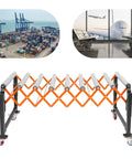 Hardcore Adjustable Roller Conveyor Table, 176 Lb Heavy Duty Expandable Belt With Wheels, Easy Roll Transport Rig For Warehouses, Docks, Stores And Shipping Hubs in front of shipping containers and airport.