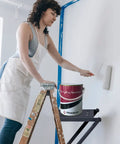 Woman using Pro Grade Heavy Duty Ladder Platform With 400 Lb Capacity Anti Slip Standing Surface And Tool Tray for painting