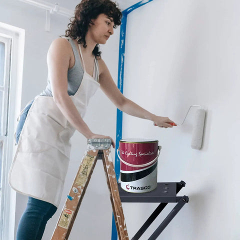 Woman using Pro Grade Heavy Duty Ladder Platform With 400 Lb Capacity Anti Slip Standing Surface And Tool Tray for painting